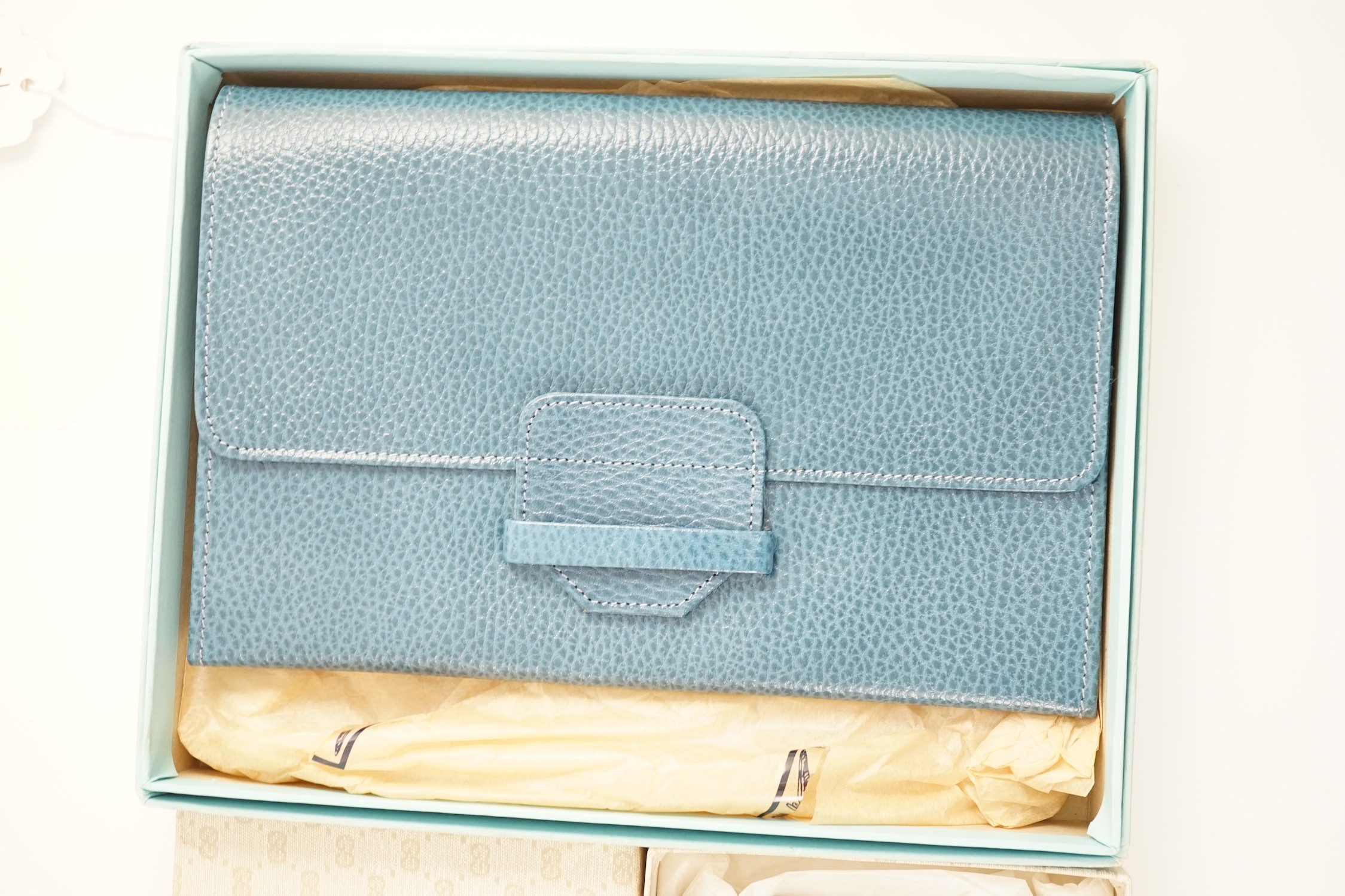 A Gucci blue leather address book, a Smythson leather travel wallet and a Christian Dior desk clip, all boxed.